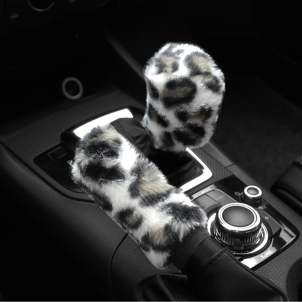 Car handbrake and gear shift cover with leopard print design on a black background