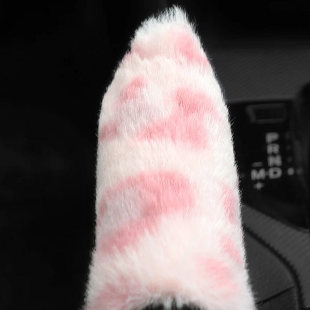Close-up of a pink and white checkered handbrake cover 